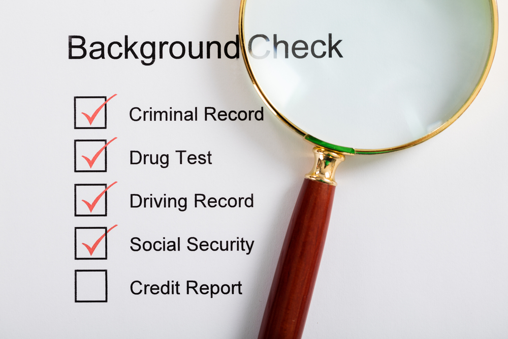 background check with magnifying glass